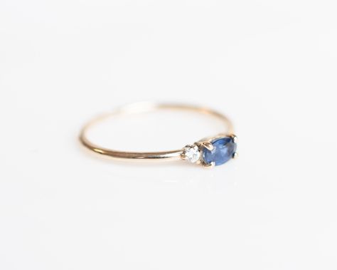 A deep blue sapphire paired with two radiating white diamonds, the Blue Sapphire Ring is captivating with it's brilliance and beauty. Delicately balanced with two light-catching diamonds, the center sapphire is a symbol of sincerity, virtue and good fortune that also embodies elegance. - 14k solid gold - 2 x 1.7mm round white diamonds - 5 x 3mm blue sapphire - Enjoy 30-day returns Quality: Our diamonds average SI or better so can they sparkle and shine for years to come. Our jewelry is only made Halo Engagement Ring Wedding Band, Sapphire Wedding Rings, Engagement Rings Vintage Halo, Blue Sapphire Ring, Diamond Engagement Rings Vintage, Sparkle And Shine, Rhodolite Garnet, Matching Rings, Blue Sapphire Rings