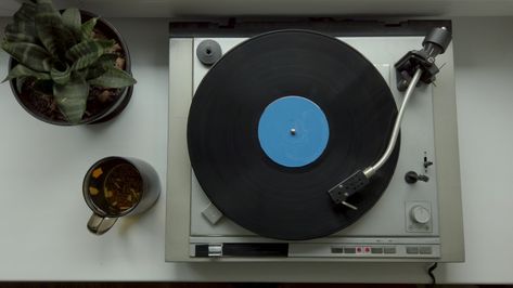 View from above on vintage vinyl record spinning on old vinyl record player. Male hand puting cup of tea on a table Old Record Player, Birdseye View, Old Vinyl Records, View From Above, Vinyl Record Player, Male Hands, Vintage Vinyl Records, Vintage Vinyl, Record Player