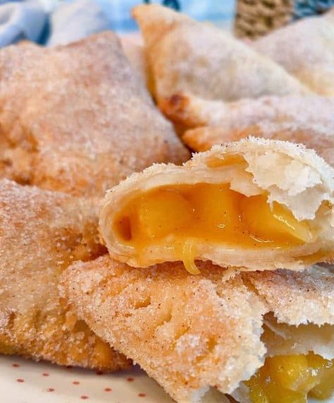 Fried Hand Pies are a classic southern treat! Fresh Peaches with a hint of cinnamon inside a super tender flaky homemade pie crust, fried, and sprinkled with cinnamon sugar. The BEST hand pie recipe you'll ever need! Peach Cobbler Hand Pies, Baked Peach Hand Pies With Fresh Peaches, Recipe For Fresh Peaches, Hand Fried Pies, Peach Turnovers Pie Crust, Homemade Hand Pies Crust Recipe, Lemon Fried Pies, Ideas For Fresh Peaches, Peach Turnovers With Fresh Peaches