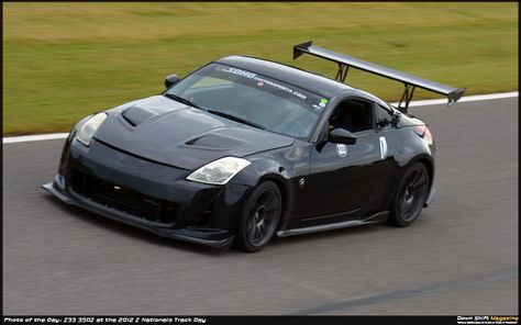 Track Prepped Nissan 350Z at Barber Motorsports Park: Featuring a spoiler that might otherwise seem garish, this track-readied and performance modified Nissan 350Z both looked and sounded quite imposing while on track. 350z Spoiler, 350z Convertible, Sick Cars, Slammed Cars, Nissan Fairlady, Car Things, Iron Man Armor, Nissan Z, Car Goals