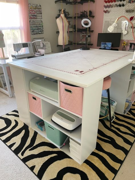 This is the final look of the table. I used Walmart Cube Organizers. I got two 3 cube x 3 cube and two 3 cube x 2 cube shelves. I put them perpendicular to each other so that it would be sturdy. I am 5’5 in height and the shelves were about 36 inches. It was the perfect height for me to stand and cut my fabric. Counter height stools (~30 inches) are great for this. Cube Craft Table, Craft Table With Cube Storage, Ikea Cube Craft Table, Cube Shelf Craft Desk, Craft Room Storage Using Cubes, Office/craft Room, Diy Craft Table, Office Craft Room Combo, Craft Tables