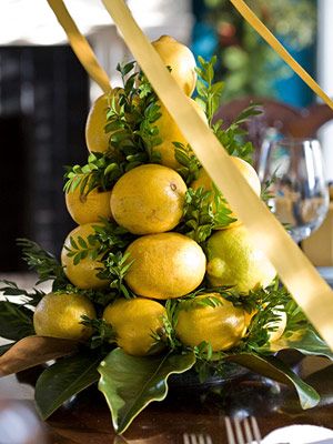 Combine lemons and greenery on a pyramid base to create miniature citrus trees perfect for a dining room centerpiece. Boxwood Tree, Christmas Greens, Dining Room Centerpiece, Tree Centerpieces, Midwest Living, Christmas Fruit, Tabletop Christmas Tree, Citrus Trees, Lemon Tree