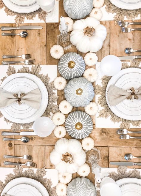 white fall table, beautiful neutral fall table with pops of silver and beautiful staggered pumpkin center piece- faux leather square placement, sandy-hued leaf shaped placemat on top to create contrast White Pumpkin Tablescape, Autumn Table Settings, Rustic Tablescape, Pumpkin Tablescape, Fall Yoga, Silver Pumpkins, Thanksgiving 2024, Fall Entertaining, Hosting Holidays