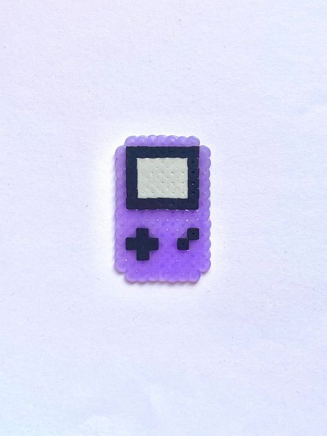 A Blast From the Past! Return to simpler times with a mini Gameboy to keep in your pocket. Our handmade gameboy constructed from Perler Beads is light weight and fun to keep as a reminder of your favorite nostalgic game. Things To Make Out Of Iron Beads, Perler Ideas Small, Perler Bead Patterns Small Easy Pokemon, Perler Bead Beach Patterns, Small Perler Bead Designs, Mini Perler Bead Patterns Easy, Small Perler Patterns, Small Perler Bead Patterns Minis, Fuse Bead Patterns Small