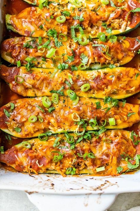 Chicken Enchilada Stuffed Zucchini Boats filled with shredded chicken, enchilada sauce, cheese, and scallions is a tasty twist on a Mexican favorite. Serve them with cilantro lime rice to make it a meal! #zucchini #zucchiniboats #chicken #dinner #lowcarb Enchiladas Lasagna, Healthy Chicken Casserole Recipes, Chicken Enchilada Sauce, Chicken Casserole Recipes Healthy, Best Chicken Casserole, Zucchini Enchiladas, Healthy Chicken Casserole, Stuffed Zucchini Boats, Easy Chicken Casserole Recipes