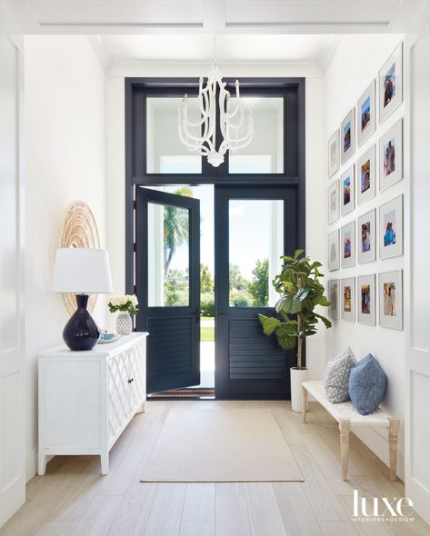 California Cool Style Comes To A Florida Home For An Active Family | Luxe Interiors + Design Coastal Entryway, Beautiful Entryways, Black Front Doors, Coastal Room, Glass Panel Door, Entrance Foyer, Transom Windows, Foyer Design, California Cool