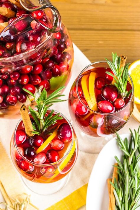 Cranberry Sangria with fresh cranberries, oranges, apples, pears and honey and garnished with a sprig of rosemary will really bring the holiday spirit to any gathering. With brandy and Cabernet Sauvignon, this sangria will have everyone cheering! via @jugglingactmama Cranberry Sangria, Fig Cookies, Large Ice Cube Tray, Apple Brandy, Sangria Recipe, Dry Red Wine, Frozen Cranberries, Festive Cocktails, Festive Drinks