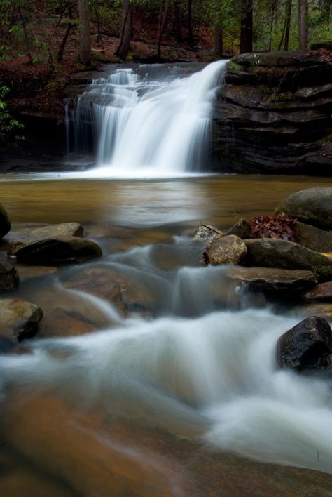 Surprise! These falls are just a short walk (1/4 mile) down a paved path from the parking lot at Table Rock State Park. The 15-foot fall rolls into a deep pool at this point. If you decide to stay on the Carrick Creek trail (it continues unpaved for 2 miles) you'll find even more surprises along the trail. More info and directions. South Carolina Waterfalls, Waterfalls North Carolina, South Carolina Hiking, South Carolina Nature, Chasing Waterfalls, Travel Europe Cheap, South Carolina Travel, Mountain Waterfall, Scenic Roads