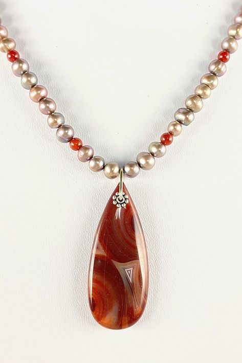 Freshwater pearls and dark carnelian necklace dangles a large red agate teardrop pendant with swirls of white, grey and red that match the color of the carnelian beads, 18"L with sterling silver clasp. #SilverNecklace #MariesGems #SilverJewelry #GiftsForHer #HolidayGifts #HolidayShopping #ShopSmall #Carnelian #FallJewelry #HostessGifts #RedAgate #FreshwaterPearls Red Agate Jewelry, Carnelian Necklace, Carnelian Beads, Necklace Red, Agate Jewelry, Teardrop Pendant, Red Agate, Fall Jewelry, Agate Pendant