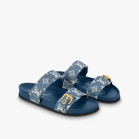 An ever-present in the Louis Vuitton shoe collection, the Bom Dia flat comfort mule is revisited in Monogram denim for a relaxed yet elegant look. This model features two adjustable straps: one with velcro and one with an engraved, gold-tone buckle. An anatomic insole and rubber outsole make this sandal extremely pleasant to wear. Louis Vuitton Slides Women, Louis Vuitton Slides, Louis Vuitton Slippers, Feminine Sandals, Louis Vuitton Heels, Fashion Shoes Heels, Cute Shoes Heels, Fashion Slippers, Girly Shoes