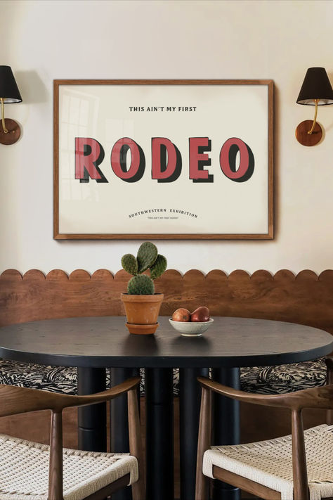 This typography print offers a retro twist on the renowned saying, "This Ain't my first rodeo." This delightful hand-painted style print is the ultimate wall decor for western, southwestern, or southern spaces. It serves as a striking statement piece in cabins, lodges, farmhouses, or ranch homes. Over The Bed Wall Decor Paintings & Prints, Organic Modern Western Decor, Minimalistic Western Decor, Rodeo House Decor, Retro Western Living Room, 70s Western Decor, Mid Century Western Decor, Ranch Decorating Ideas, Retro Western Decor