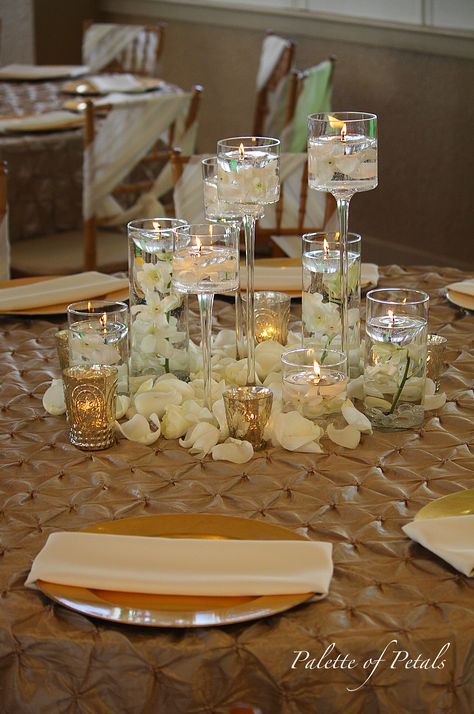 Submerged Orchids in Cylinders and Stemmed Cylinders with White Rose Petals at their feet. Lots of Candlelight and ultra romantic. Flying Candles, Submerged Flowers, White Rose Petals, Rose Petals Wedding, Dinner Party Decorations, Low Centerpieces, Jewel Tone Wedding, Great Gatsby Party, Hanging Candles