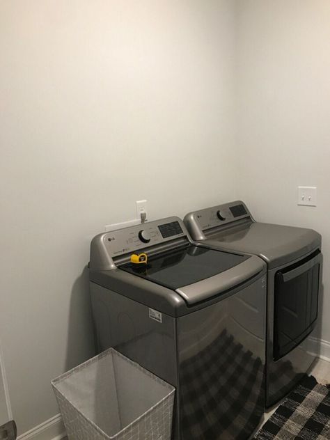 My inlaws builder grade laundry room needed a facelift on a budget. With some shelving my father in law had lying around and some peel and stick wallpaper we turned this room from drab to fab!  The before     As you can see this room needed some attention. It was a basic builder grade laundry room with only a washer and dryer and blah walls . We started with opal house peel and stick wallpaper found at target for 35 per 28 square feet. This is such a go to for us for an amazing transfo… Builder Grade Laundry Room, Small Washer And Dryer, Laundry Room Refresh, Peg Board Shelves, Buying A Manufactured Home, Opal House, Cheap Candle Holders, Laundry Makeover, Live Edge Shelves