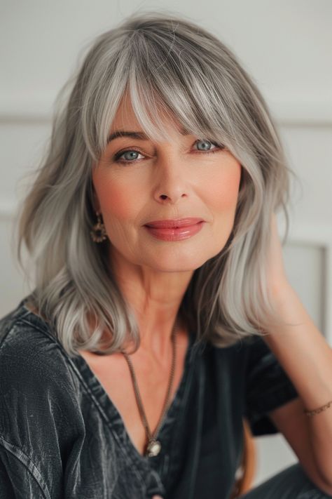 As women enter their 50s, they look for ways to update their style and feel confident and youthful. One of the best ways to transform your look after 50 is by getting bangs! The right fringe can… Layer Medium Length Hair, Styles For Thick Straight Hair, Modern Gray Hair, Layer Medium Length, Salt And Pepper Hairstyles, Bobs With Fringe, Gray Bob Hairstyles, Dimension Hair, Gray Hair Over 50