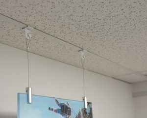 Product Spotlight: The Clever, Yet Simple Way To Hang Objects From Drop-Ceilings | Hang It Up Systems Art Hanging From Ceiling, Projector Shelf, Art Hanging System, Drop Ceilings, Ceiling Hangers, Vbs 2023, Ceiling Grid, Drop Ceiling, Ceiling Hooks