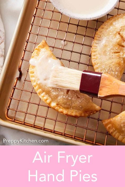 This easy recipe for air fryer hand pies is a must-try this fall! A crisp, flaky crust surrounds a spiced apple pie filling before being sprinkled with coarse sugar. They’re a delicious hand-held treat that bakes up so well in the air fryer! Air Fry Apple Pie, Airfryer Hand Pies, Air Fryer Fried Pies, Air Fryer Hand Pies, Spiced Apple Pie, Recipe For Air Fryer, Apple Pie Filling Recipes, Fruit Pie Filling, Canned Apple Pie Filling