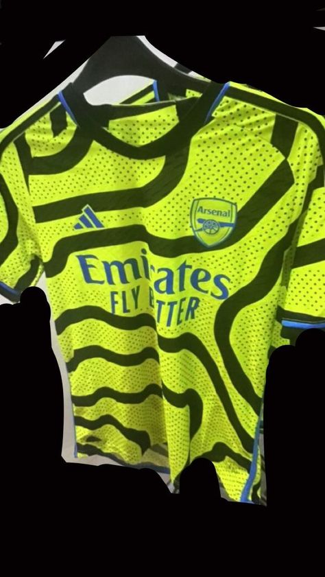 The Kitman - New from the English Premier League as leaked images of the new Arsenal 2023-24 away kit made by Adidas have appeared online. The leaked 2023-24 Arsenal away shirt is fluorescent yellow (Team Semi Solar Yellow) with thick black lines that vary in direct. The trim on the collar and cuffs is coloured blue as is [...] The post Arsenal 2023-24 Away Kit Leaked? appeared first on The Kitman | Classic Football Shirts | Retro Football Kits | Vintage Jerseys. Arsenal 2023, Arsenal Kit, Arsenal Football Shirt, Arsenal Soccer, Arsenal Shirt, Arsenal Jersey, Arsenal Football Club, Adidas Jersey, Arsenal Football