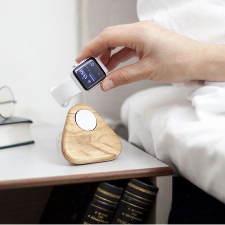 A charging stand milled from one solid block of olive wood. 
Turns your Apple Watch to a night clock while
charging. A charger and alarm clock by night. A sculpture by day. Apple Watch Stand Diy, Diy Headphone Stand, Apple Watch Holder, Wood Iphone Stand, Diy Apple, Apple Watch Charging Stand, Apple Watch Stand, Apple Watch Fashion, Wood Apples