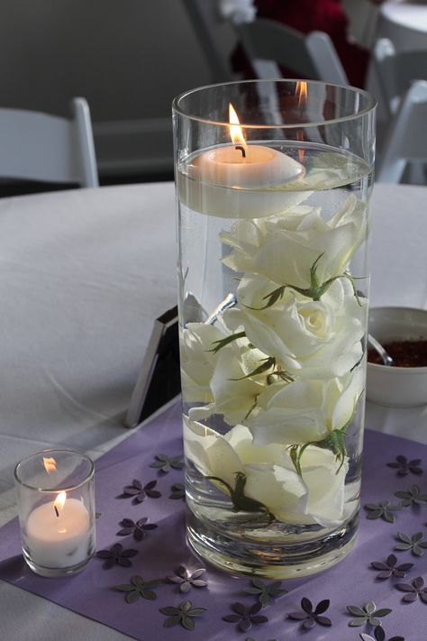 Submerged Rose Centerpieces with Floating Candle                                                                                                                                                      More Dollar Tree Floating Candle Centerpieces, Water Candle Centerpiece, Wedding Center Pieces With Floating Candles, Rose In Water Centerpiece, Floating Candles Wedding Centerpieces Floating Pearls, White Rose In Water Centerpiece, Water Bowl With Flowers Floating Candles, White Rose Floating Candle Centerpiece, Roses In Water Centerpiece Floating Candles