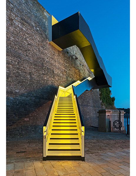 As part of the regeneration of the 19th-century Royal William Yard in Plymouth, England, Gillespie Yunnie Architects designed a staircase to connect pedestrians from the former naval supply yard to the South West Coast Path, a 630-mile trail that runs from Minehead in Somerset to Poole Harbour in Dorset. Concealed LED lights change the color of the stairwell. Photo: Richard Downer Restoration Architecture, Stair Inspiration, Arch Stairs, Plymouth Uk, Architecture Cool, Multipurpose Hall, Architecture School, Performance Stage, Stairs Architecture