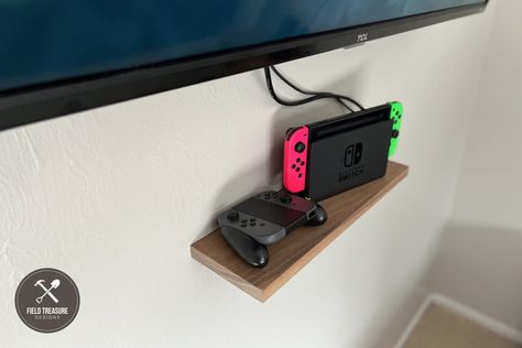 Keeping the Nintendo Switch on the floor was too cluttered so I made this floating shelf out of a piece of walnut that I have had sitting around for years! Now the components are neatly stored under the TV on the wall. Using a “Keyhole Router Bit” I was able to make this project happen […] The post How to Make a Floating Shelf appeared first on Field Treasure Designs. Nintendo Switch Shelf, Tv On The Wall, Walnut Uses, Blue Yeti, Dust Extractor, Router Bit, Miter Saw, Floating Shelf, Router Bits