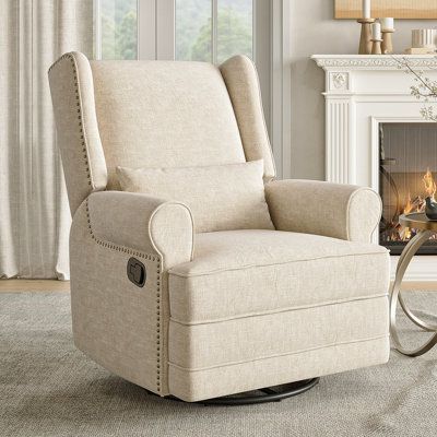 This rocking recliner offers the ultimate relaxation with its 360° swivel and gentle gliding motion. Upholstered in fade-resistant microfiber, it features a solid wood frame and metal legs for a sleek look. The ergonomic design includes a manual reclining mechanism and a hidden footrest for added comfort. Ideal for nurseries or bedrooms, this recliner also comes with a coordinating accent pillow for an added layer of texture. We suggest wiping it down with mild soap and water to keep it looking Rocking Chairs Living Room, Stylish Recliners In Living Room, Slipcover Recliner, Recliners In Living Room, Stylish Recliners, Small Recliners, Feeding Chair, Rocking Recliner, Swivel Rocker Recliner Chair