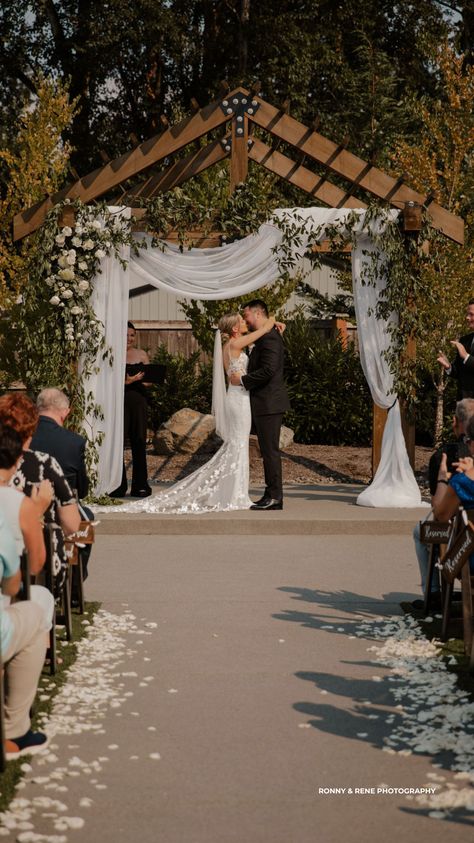 Vintage Summer Wedding Arbor With White Roses & Greenery Vintage Summer Wedding, Wedding Venue Outdoor, White Rose Petals, Wedding Arbor, Wedding Venues Indoor, Wedding Arbour, White Drapes, Floral Lace Dress, Indoor Wedding