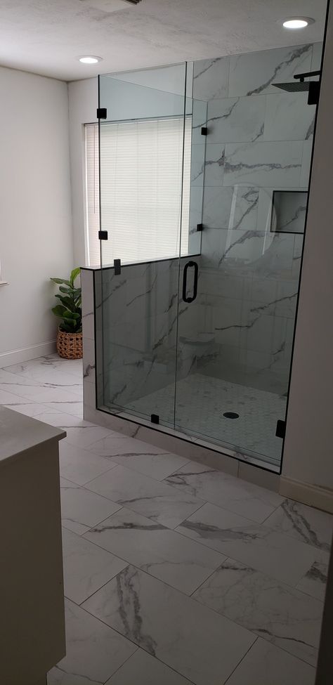 White and grey tile shower with custom glass doors and pony wall Shower Pony Wall Ideas Tile, Glass Shower With Pony Wall, Shower With Pony Wall And Glass Door, Shower Pony Wall, Shower With Pony Wall, Shower Half Wall Ideas, Shower Pony Wall Ideas, Shower With Half Wall And Glass Door, Pony Wall Shower Ideas