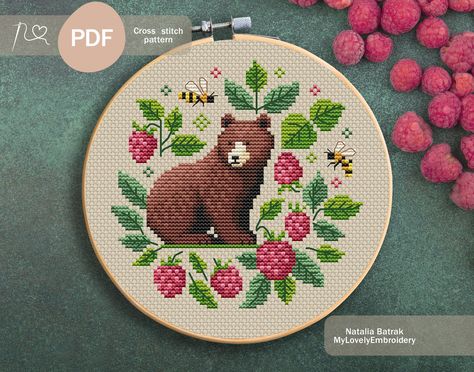 Create a charming piece of art with easy, beginner friendly cross stitch pattern featuring a bear surrounded by ripe raspberries. This primitive design is perfect for those new to cross stitching and adds a rustic touch to any space. Download now and start stitching your cozy forest scene today! Cross stitch pattern "Bear and raspberries" Stitches: 71 x 70 Palette: 17 colors DMC  Recommended canvas color: cream or white Stitch: full cross, backstitch Size: 14 count Aida - 5.07 x 5.00 inches or 1 Teacup Cross Stitch Pattern, Woodland Cross Stitch, Cow Cross Stitch, Bear Cross Stitch Pattern, Bear Cross Stitch, Cozy Forest, Primitive Cross Stitch, Primitive Cross Stitch Patterns, Sampler Cross Stitch