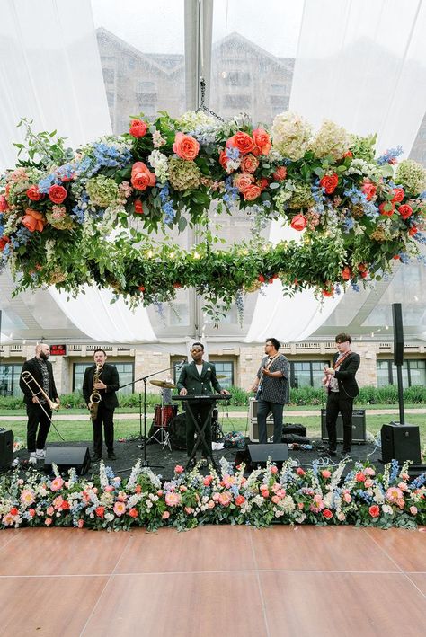 Coral rose, green hydrangea, blue delphinium, peach blush stock, white snapdragons wedding floral chandelier installation Snapdragons Wedding, Snapdragon Wedding, Band Setup, Chandelier Installation, Hydrangea Garland, Colorful Summer Wedding, Hydrangea Blue, Blue Delphinium, Creative Wedding Gifts