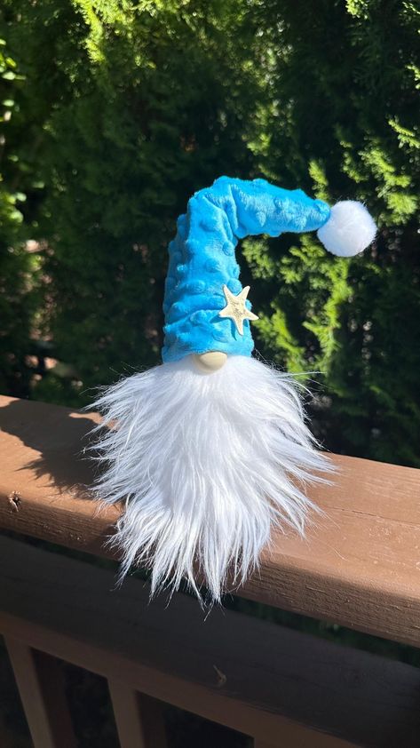 Beautifully handmade beachy gnomes. Made with Styrofoam, fabric and faux fur they are light weight finished with beach accessories, sign, shells or wood embellishment. I also add a metal weight in the bottom to prevent tip-over. Size foam approx 3" wide to 6" height, the height depends the way you style the hat   it can be around 8"- 11" tall. These cute gnomes are not a toy, decor only. Many different styles availble in my Etsy store. If you are not completly satisfied with your purchase, pleas Fabric Gnomes, Beach Gnomes, Cute Gnomes, Gnome Gift, Scandinavian Gnomes, Beach Accessories, Christmas Gnome, Decor Christmas, Beach Decor