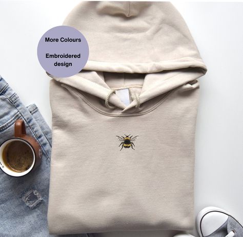 Bumble Bee Embroidered Hoodie, a delightful addition to your wardrobe! This Unisex Embroidered Bee Hoodie is perfect for bee lovers and beekeepers alike, making it an ideal gift idea. Adorned with intricate bee embroidery, this cozy hoodie is not only stylish but also celebrates the beauty of these fascinating creatures. Stay cozy and stylish while showing your love for bees with this unique piece of bee embroidered clothing! . . .. . . #BeeEmbroideredHoodie #BeeLovers #BeeKeepers #BeeFashion... Bee Hoodie, Embroidered Bee, Bee Embroidery, Cozy Hoodie, Embroidered Clothes, Embroidered Hoodie, Bee Keeping, Stay Cozy, Embroidered Design