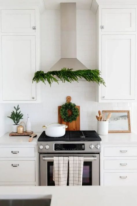 I think greenery is one of the most important parts of Christmas decor! And today I’m sharing the 10 ways you can use holiday greenery throughout your home this holiday season!Yes, 10.So even if you don’t have a mantel to fill with garlands, this one is still for you!Note- I’ll be linking items as I go, and I will also put a link to shop everything at the bottom of the post.Different ways to use holiday greenery throughout your home:1. The obvious – a mantel Starting with the obvious… Kitchen Hood Wreath, Wreath Over Stove Vent Hood, Kitchen Hood Christmas Decor, Range Hood Christmas Decor, Wreath On Range Hood, Wreath Above Stove, Kitchen Hood Ideas, Christmas Dining Room Decor, Hood Vents