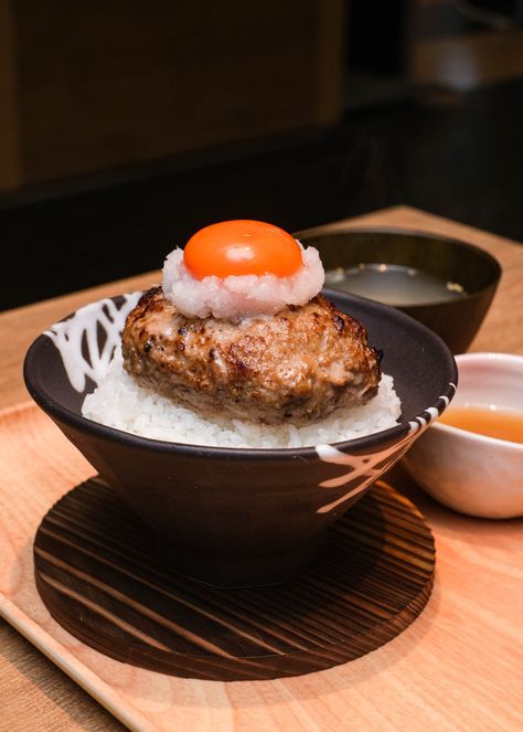 Tsukimi Hamburg Don - expect steaming rice, drizzled with bonito and kombu stock and topped with a thick Hamburg steak. Hamburg Steak Japanese, Japanese Diner, Japanese Hamburger Steak, Hamburg Steak, Japanese Food Photography, Sushi Go, Japanese Bakery, Japanese Beef, Japanese Dining