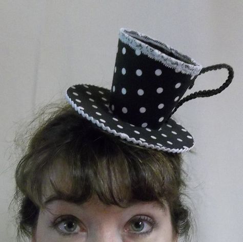 a tea cup hat Alice In Wonderland Mad Hatter Hat, Tea Cup Hat, Teacup Hat, Top Hats For Women Mad Hatters, Tea Fairy, Mad Hatter Makeup, Alice In Wonderland Top Hat, Mad Hatter Mini Hat, Cup Hat