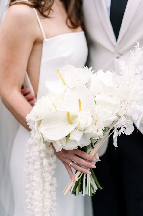 Bride in Modern Gown Holding All-White Cascading Bouquet of Roses, Calla Lilies and More Wildflower Arrangements, Monochromatic Wedding, Bridal Bouquet Ideas, Modern Gown, Calla Lily Flowers, Cascading Wedding Bouquets, Cascading Bouquet, Wedding Roles, Bouquet Of Roses