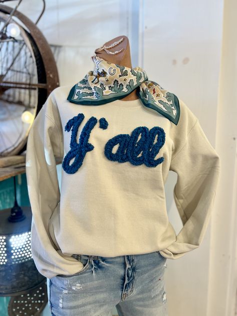 Get cozy in this Y'all cream sweatshirt with a teal puff graphic stitched on the front. Perfect for any western lover, this quirky and fun top adds a playful touch to any outfit. Yeehaw! 100% Cotton Womens Cozy Fall Outfits, Southern Chic Fashion, Western Embroidered Sweatshirt, Fall Concert Outfit Country, Cozy Mom Outfits, Country Casual Outfits, Wester Wear, Country Concert Outfit Fall, Trending Embroidery