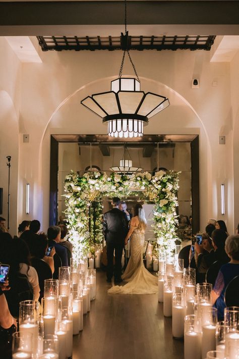 Candlelit Jewish Wedding Ceremony Wedding Aisle Candles Indoor Ceremony, Chuppah White Flowers, Inside Wedding Ceremony, Flower Chuppah, Wedding Chuppah Flowers, Aisle Greenery, Huppah Wedding, Wedding Aisle Candles, Chapel Decor