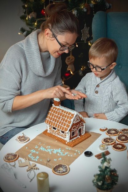 Photo little boy with mom decorate chris... | Premium Photo #Freepik #photo #christmas-family #gingerbread-house #new-year-family #gingerbread Gingerbread House Photoshoot, Gingerbread House Decorating, Decorate Christmas, Gingerbread House Decorations, Gingerbread Decorations, Christmas Gingerbread House, Christmas Photoshoot, House Decorating, Photo Christmas