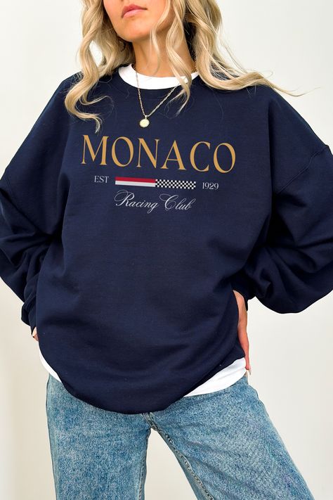 The Monaco Sweatshirt is the perfect addition to any racing lover's wardrobe. This crewneck sweatshirt boasts an iconic Monaco Racing Club logo on the front, making it a stylish and comfortable way to show your love for the sport. Whether you're wearing it to the track or to a casual Sunday brunch, this sweatshirt is sure to turn heads. The soft and cozy fabric makes it perfect for cooler weather, and the preppy style ensures that you'll look great no matter where you go. Monaco Sweatshirt, Vegas Bachelorette Party Shirts, Scottsdale Bachelorette Party, Bachelorette Merch, Las Vegas Bride, F1 Merch, Luxury Bachelorette, F1 Aesthetic, Scottsdale Bachelorette