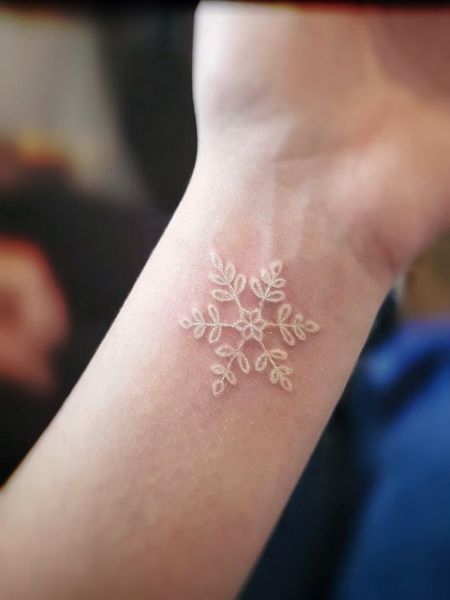 White Snowflake Tattoo White Snowflake Tattoo, Snow Flakes Tattoo, White Wrist Tattoos, Small Snowflake Tattoo, Tattoo Ideas And Meanings, Snowflake Tattoos, Snowflake Tattoo, Winter Tattoo, Snow Tattoo