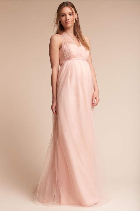 Jenny Yoo Serafina Maternity Dress.  Crafted from soft tulle, this maternity dress is comfortable and flattering with its shirred, strapless bodice, sweetheart neckline, and empire waist. It’s incredibly versatile, too—the A-line skirt features convertible side panels that can be wrapped and tied over the bodice for 15+ looks! Maternity Bridesmaid Dress Long, Pregnant Bridesmaid Dress, Maternity Bridesmaid Dress, Bridesmaid Dress Ideas, Pregnant Bridesmaid, Maternity Bridesmaid Dresses, Blush Bridesmaids, Pregnant Wedding Dress, Blush Bridesmaid Dresses