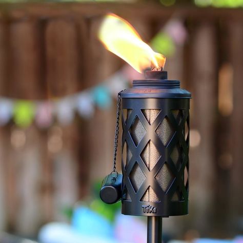 A steel citronella garden torch to keep away the mosquitos during all your summer evening activities — like stargazing, s'mores-making, barbecues, and pool parties. Modern Lattice, Garden Torch, Metal Pole, Tiki Torches, Lattice Design, Beautiful Centerpieces, Smart Lighting, Mid Size, In Ground Pools