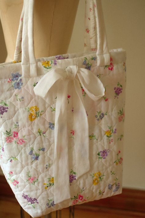 Whimsical quilted tote bag with forget-me-not appliqué and grosgrain ribbon ties. Perfect for everyday Quilted Bag Patterns, Fabric Shopping, Heart Pillows, Floral Tote Bag, Quilted Tote Bags, Denim Tote Bags, Quilted Totes, Mini Tote Bag, Crochet Bag Pattern