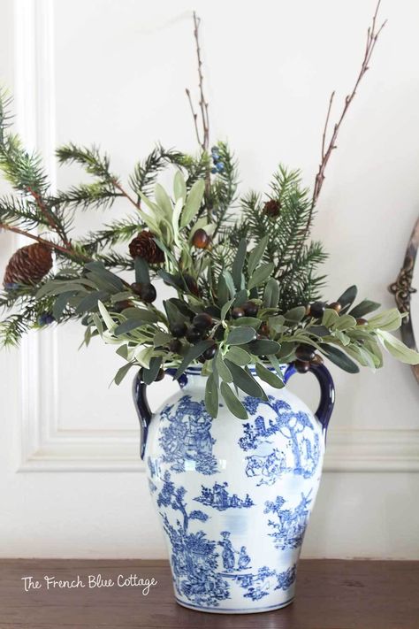 Winter greenery arrangement with olive branches. #gingerjar #winterdecor Winter Floral Arrangements Home, After Christmas Decorating, Winter Mantel Decorating Ideas, Glass Jugs Decor, January Decorating Ideas, January Decor After Christmas, Decorating After Christmas, After Christmas Decor, Winter Decorating Ideas