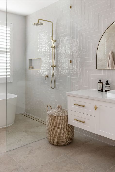 This hamptons style bathroom features a single shaker vanity, with an arch mirror and brushed brass tapware. Hamptons Bathroom Ideas Coastal Style, Hampton Bathroom Ideas, Bathroom With Gold Fixtures, Modern Hamptons Bathroom, Hamptons Bathroom Ideas, Hampton Style Bathroom, Hampton Style Bathrooms, Small Ensuite Bathroom, Coastal Hamptons Style