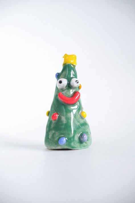 -Handmade Ceramic Green Silly Christmas Tree designed by Kiwi Poca -About this ornament: Each piece is unique and may vary slightly from the item shown. Hand-wash is recommended. Be careful against sudden temperature changes. Size: 6 cm x 3 cm Price: €35 Simple Clay Ornaments, Air Dry Clay Christmas Tree Ornaments, Christmas Airdry Clay Ornaments, Holiday Ceramics, Christmas Clay Ornaments, Clay Christmas Tree, Silly Christmas, Kitschy Christmas, Christmas Tree Green