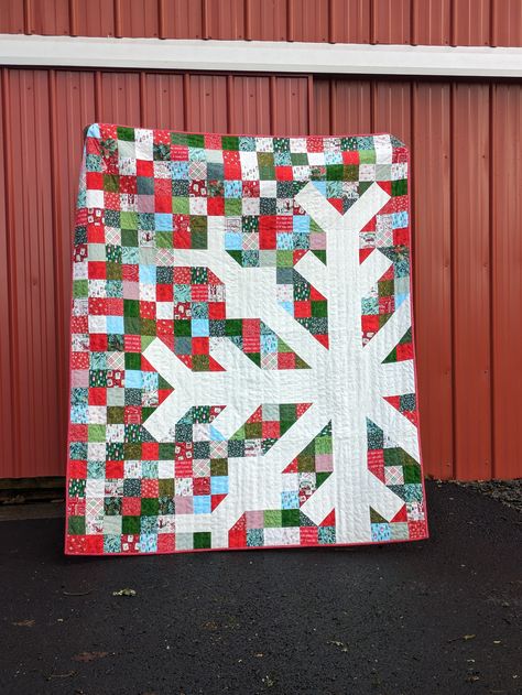 This festive Christmas throw quilt is a fun Snowflake Pattern. I used a variety of Christmas prints in reds and greens for a fun scrappy look. The back of the quilt is a beautiful poinsettia print. The binding is a bright red and white dot fabric that is handsewn to the back of the quilt. This quilt was carefully made to be enjoyed for many years to come.  The finished size of this throw quilt is 60x 72 inches. This quilt would be a great holiday cuddle blanket, holiday decoration or a memorable gift!  The fabrics and batting are cotton. Machine wash cold. The fabric will shrink slightly, creating a soft, crinkly texture that becomes softer with each wash. *Quilt pattern is the Snowflake pattern from NICOLE DAKSIEWICZ with Modern Handcraft Poinsettia Quilt, Christmas Textiles, Modern Christmas Quilt, Snowflake Quilt, Quilt Christmas, Red And Green Christmas, Cuddle Blanket, Christmas Throws, Christmas Poinsettia