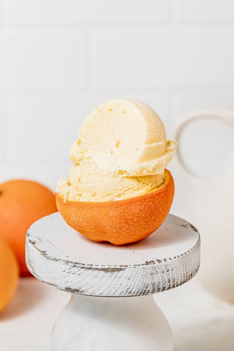 Long summer days should be enjoyed with a bright, refreshing frozen dessert, like this easy homemade orange sherbet that tastes of sunshine and happy childhood memories. This nostalgic frozen treat is shockingly easy to make and can be made with or without an ice cream maker. Serve generous scoops of the naturally orange colored and flavored ice cream into an adorable orange peel bowl or a classic sugar cone! Homemade Orange Sherbet, How To Make Sherbet, Orange Sherbet Recipe, Chocolate Raspberry Mousse Cake, Chocolate Orange Cheesecake, Sherbet Recipes, Orange Pound Cake, Flavored Ice, Orange Chocolate Cake