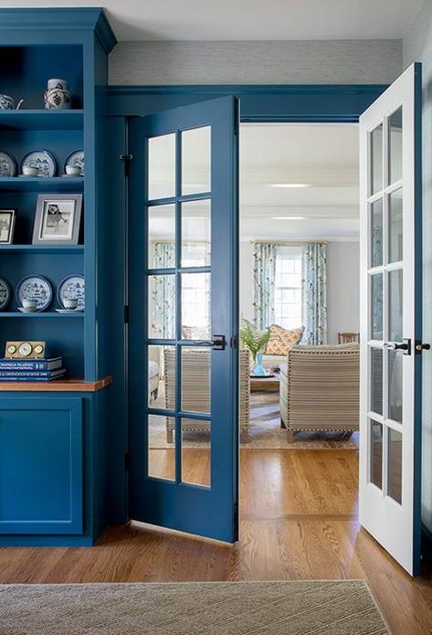 Two tone white and blue French doors open to a gorgeous blue home office fitted with built in blue cabinets accented with a wood countertop mounted beneath built-in blue styled shelves. Blue French Doors, Blue Home Interior Design, Home Office French Doors, Blue Home Interior, Library Doors, Blue Interior Doors, Office French Doors, Studio Doors, Office With French Doors